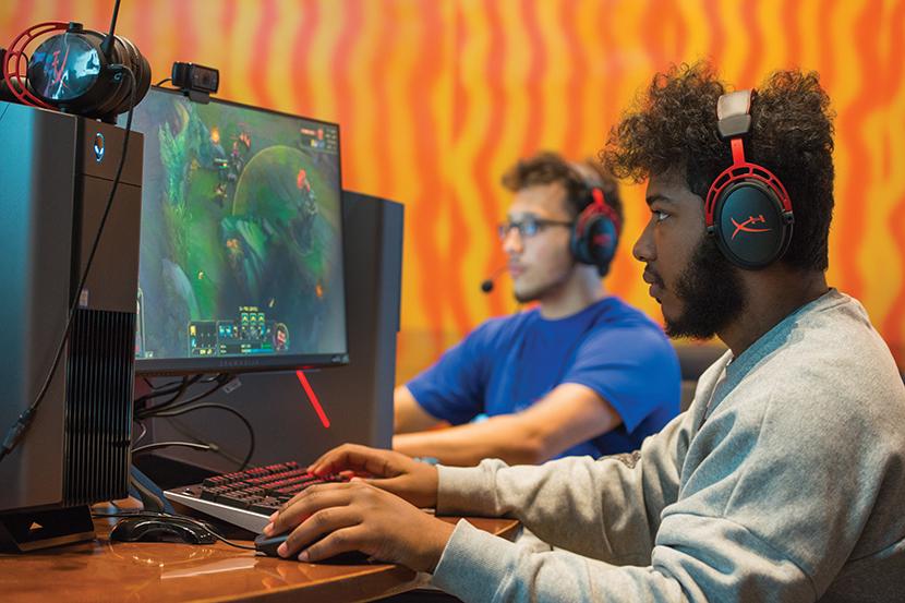 Undergraduate students in the Esports room working on computers